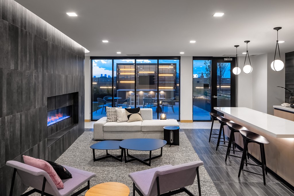 a living room with a fireplace and a table with chairs