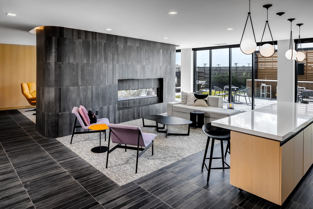 a living room with a table and chairs and a kitchen