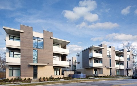 a row of modern apartment buildings on the side of a street