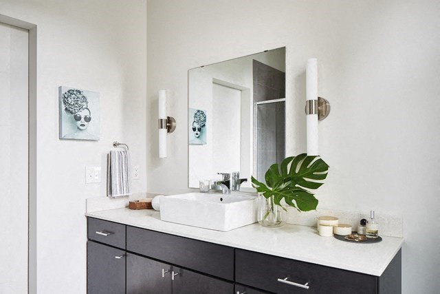 a white bathroom with a sink and a mirror