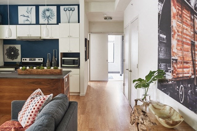 a living room with a couch and a kitchen