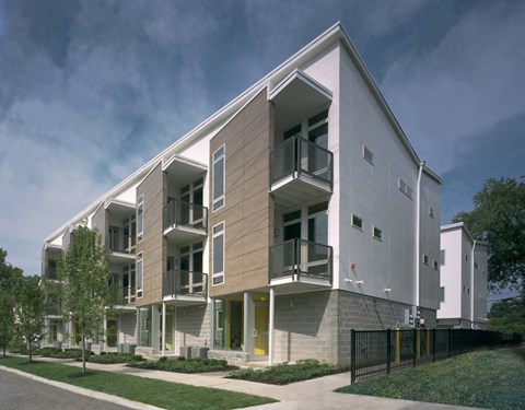 a rendering of a three story apartment building with balconies