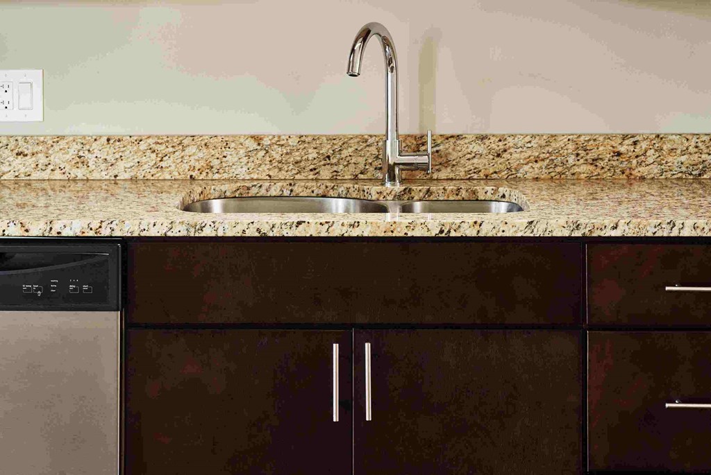 a kitchen with a sink and a faucet