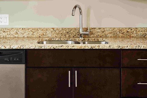 a kitchen with a sink and a faucet