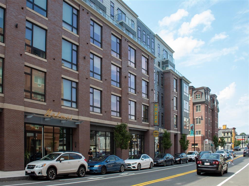 Beverly MA Apartments for Rent - Holmes Beverly - Exterior View of Holmes Beverly with Street View, Trees, and Urban Environment