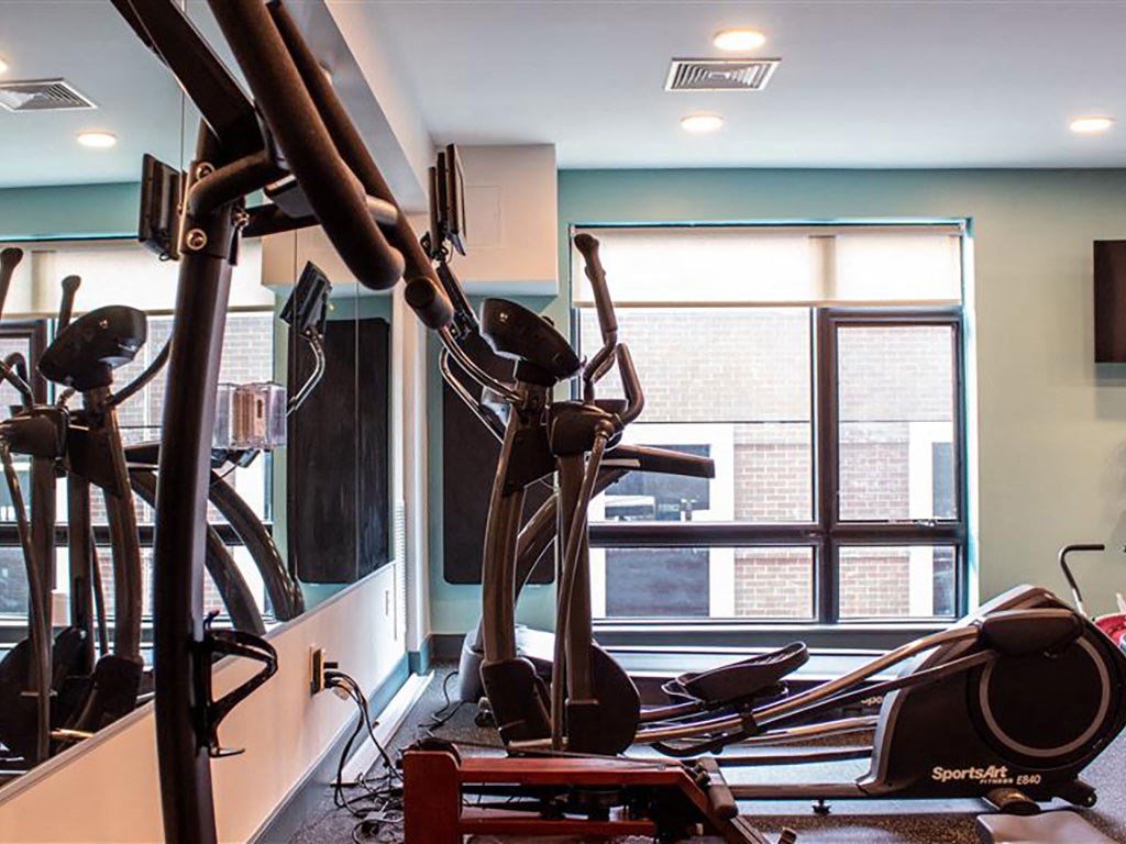 Beverly, MA Apartments- Holmes Beverly- Wall Mirror with Fully Equipped Gym and Large Windows