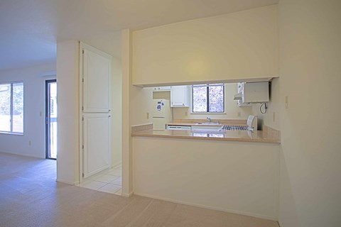 A white room with a desk and a window.