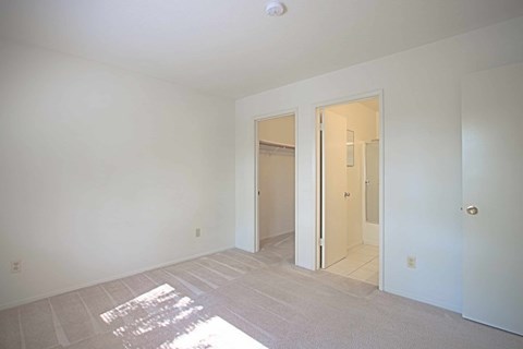 A room with a white door and a white wall.