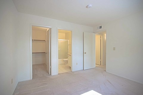 A white room with three open doors.