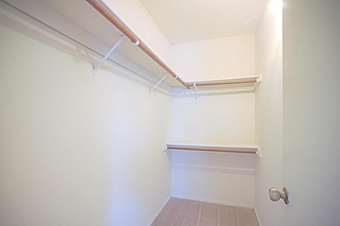 A white wall with a brown trim and a white door.