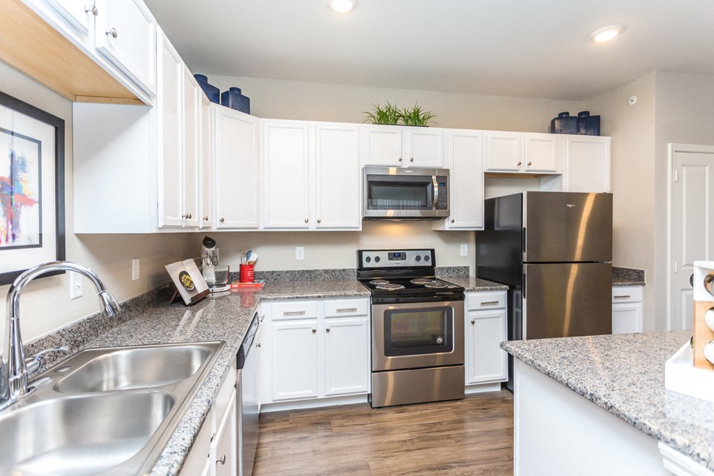 a kitchen with stainless steel appliances and granite counter tops