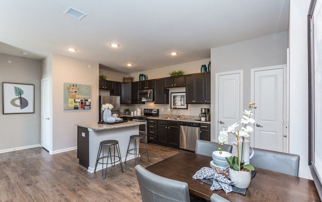 an open kitchen and dining area with a table and chairs