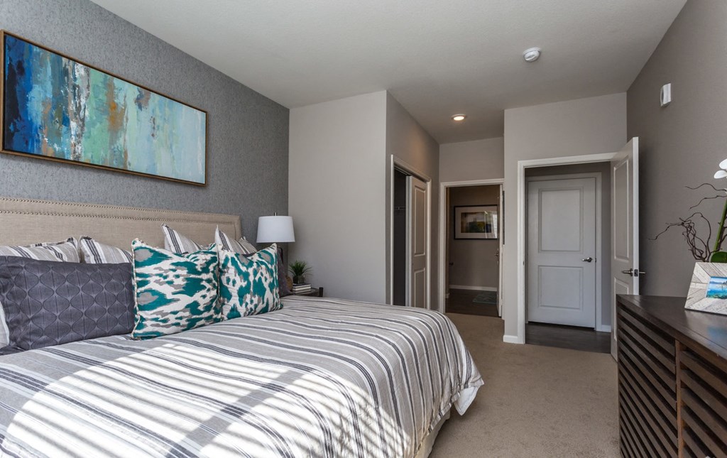 a bedroom with a bed and a door to a bathroom