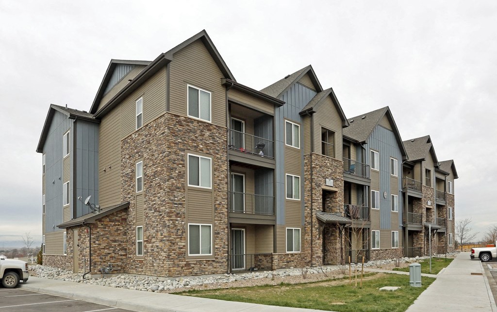 a row of apartment buildings with stone and gray roofs