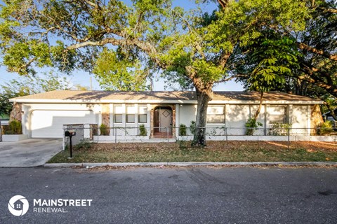 a white house with a tree in front of it