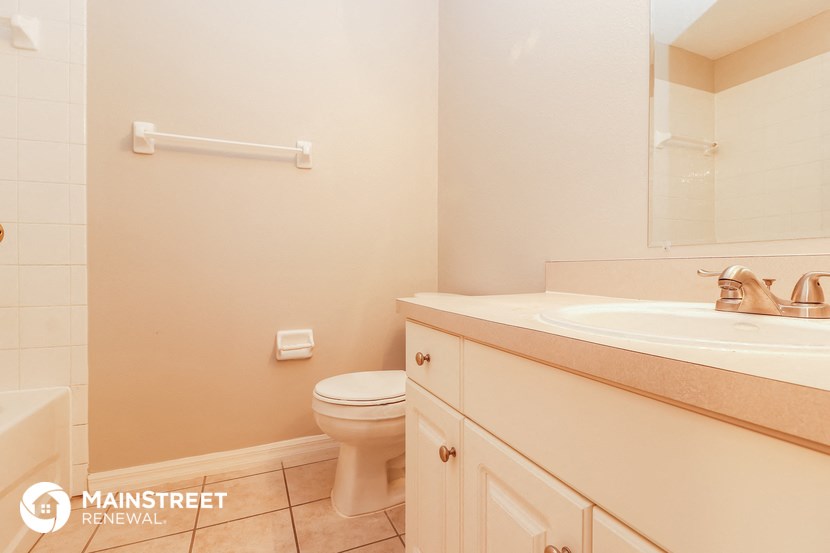 a bathroom with a sink toilet and a mirror