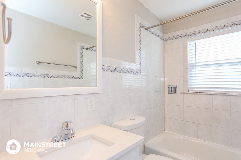a bathroom with a sink and a mirror and a toilet