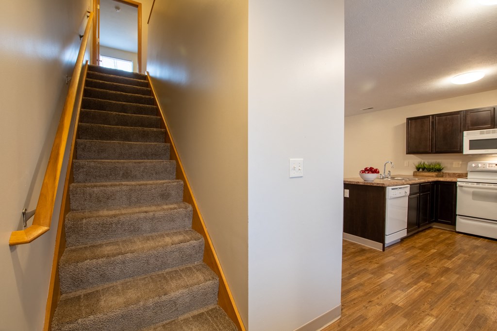 the view of a staircase in a home with a kitchen