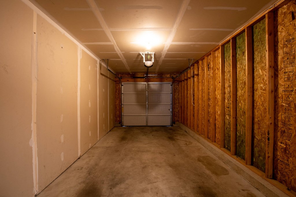 a room with a garage door and a light on the ceiling