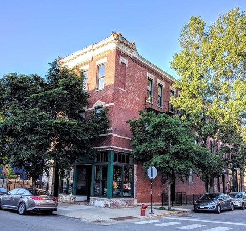 a brick building on the corner of a city street
