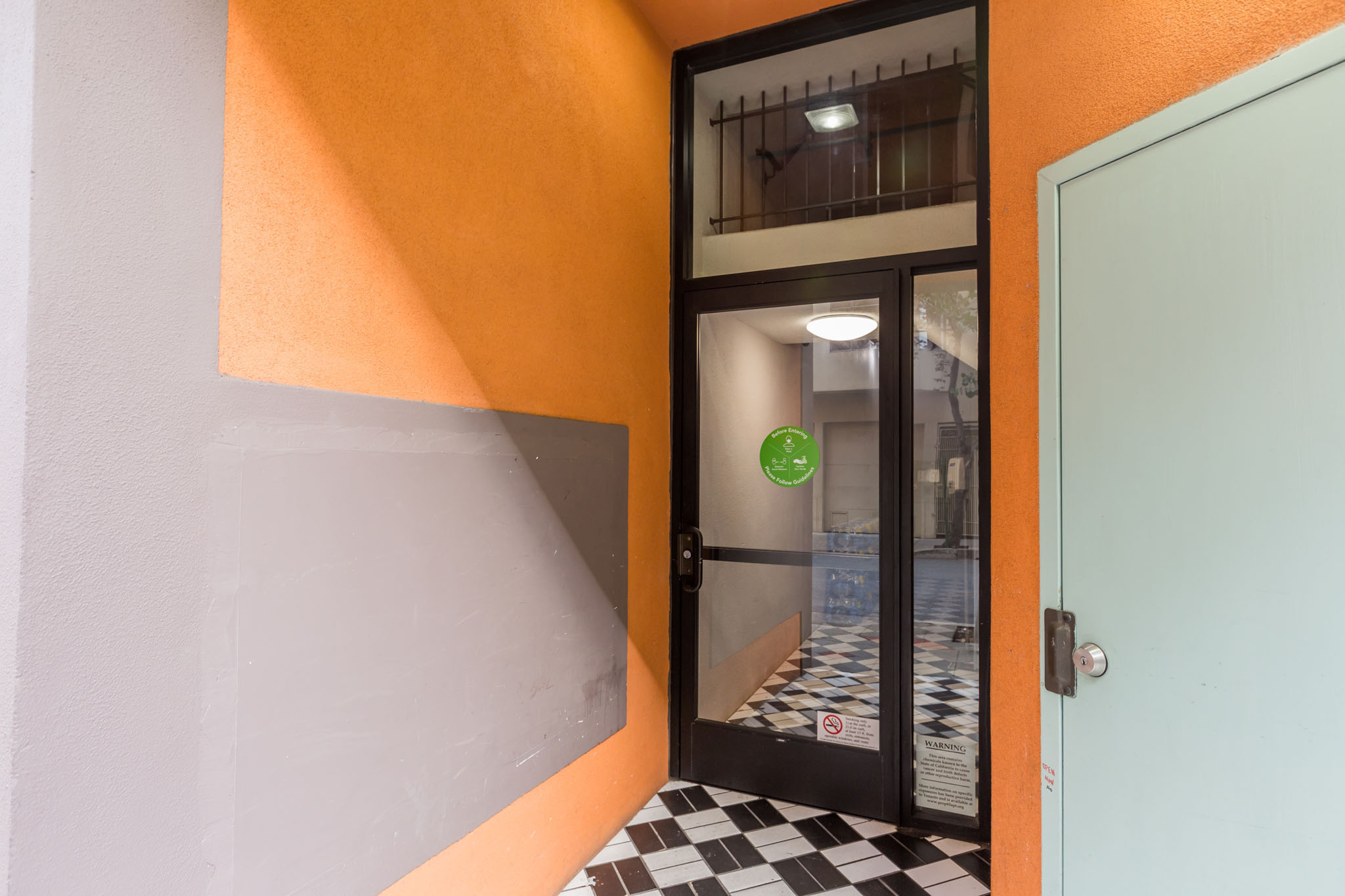 A door with a green sign on it is open.