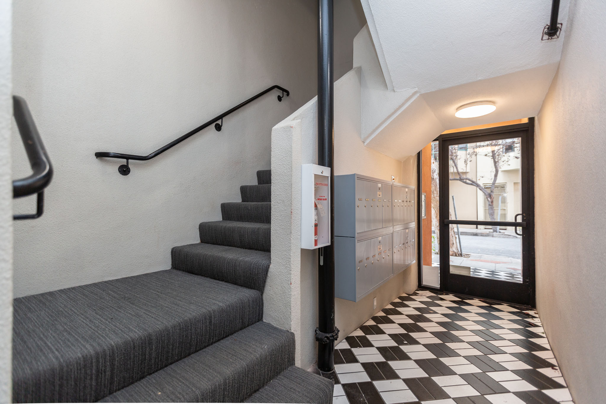 A staircase with a black and white checkered floor.