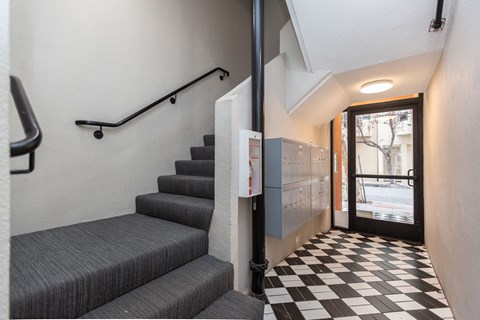 A staircase with a black and white checkered floor.