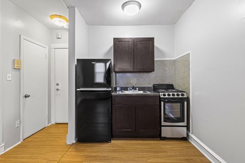 a small kitchen with a stove refrigerator and sink