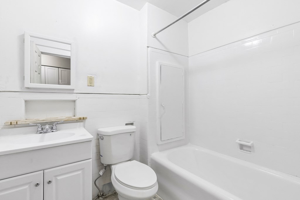 a bathroom with a sink toilet and a bath tub