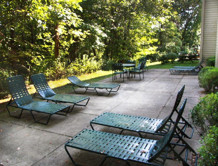 a patio with chairs and tables on a patio