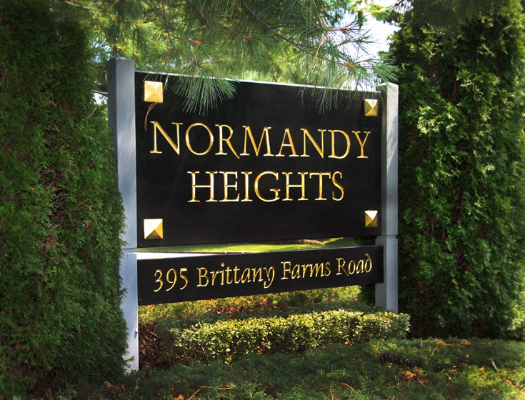 a sign heights in front of trees