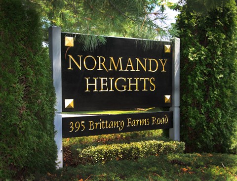 a sign heights in front of trees