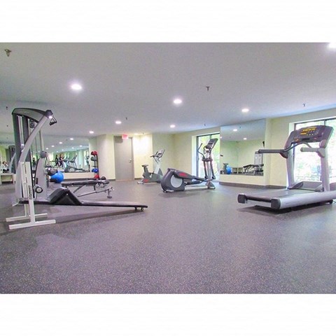 a gym with treadmills and other exercise equipment
