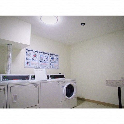 a laundry room with a washing machine and a sign on the wall