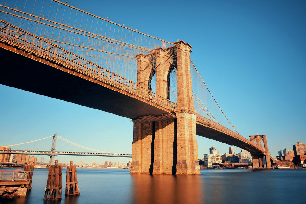 A large bridge with a suspension design is shown in the image.