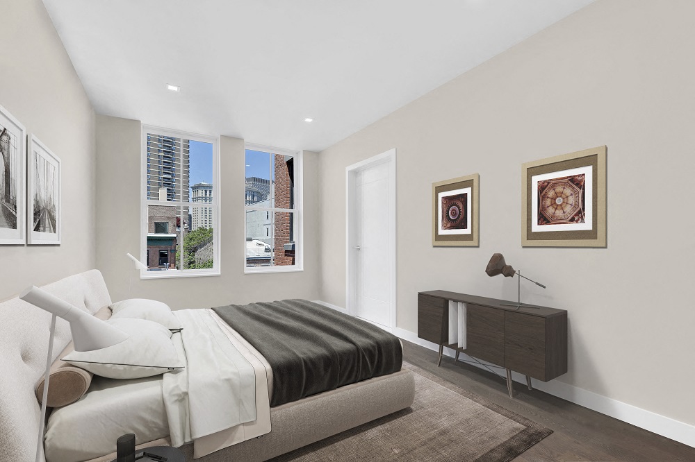 A bedroom with a large bed and a brown rug.
