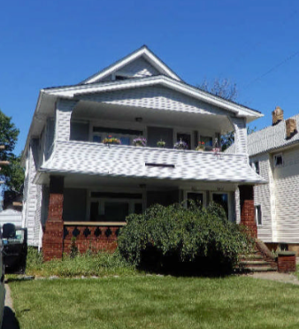 a white house with a white roof and a green lawn
