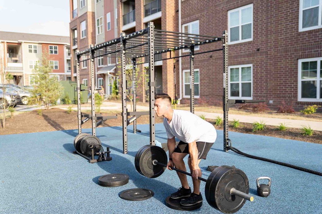 A Man Lifting Weight at The Aster Apartments, Cary, NC