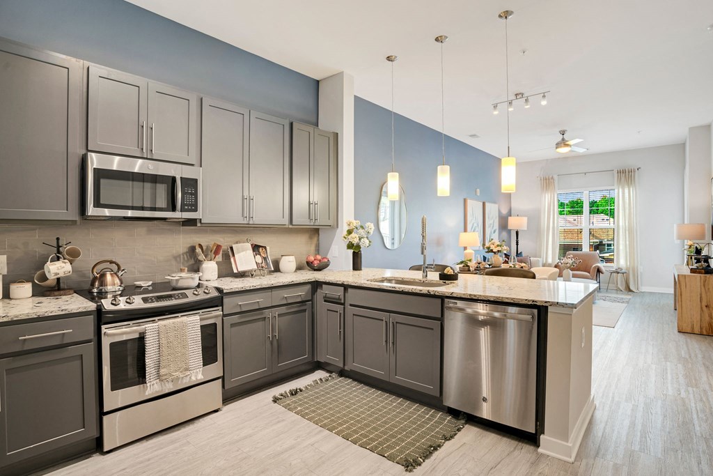 A Kitchen With a Large Island at The Aster Apartments, Cary, NC