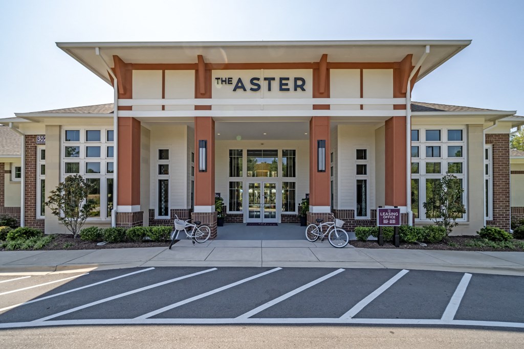 the exterior of theaster building with bikes parked in front of it