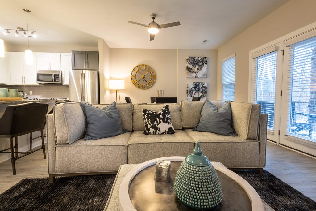 A Living Room With a Green Lamp at The Aster Apartments, North Carolina