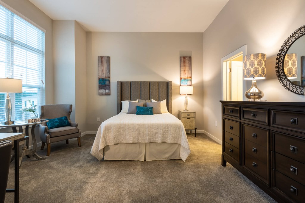 A Bedroom With a Dresser at The Aster Apartments, Cary, NC