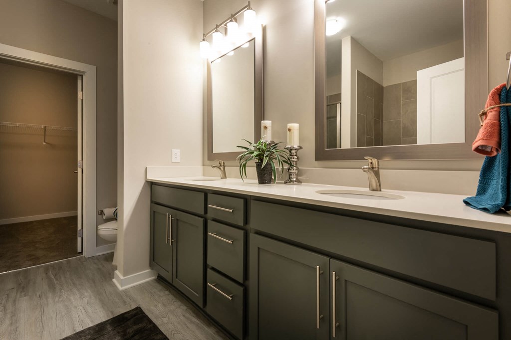 A Bathroom With a Large Mirror at The Aster Apartments, Cary, 27519