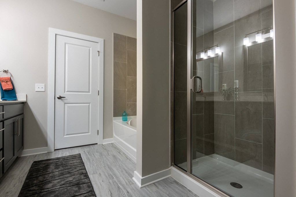 A Bathroom With a White Door at The Aster Apartments, Cary, North Carolina