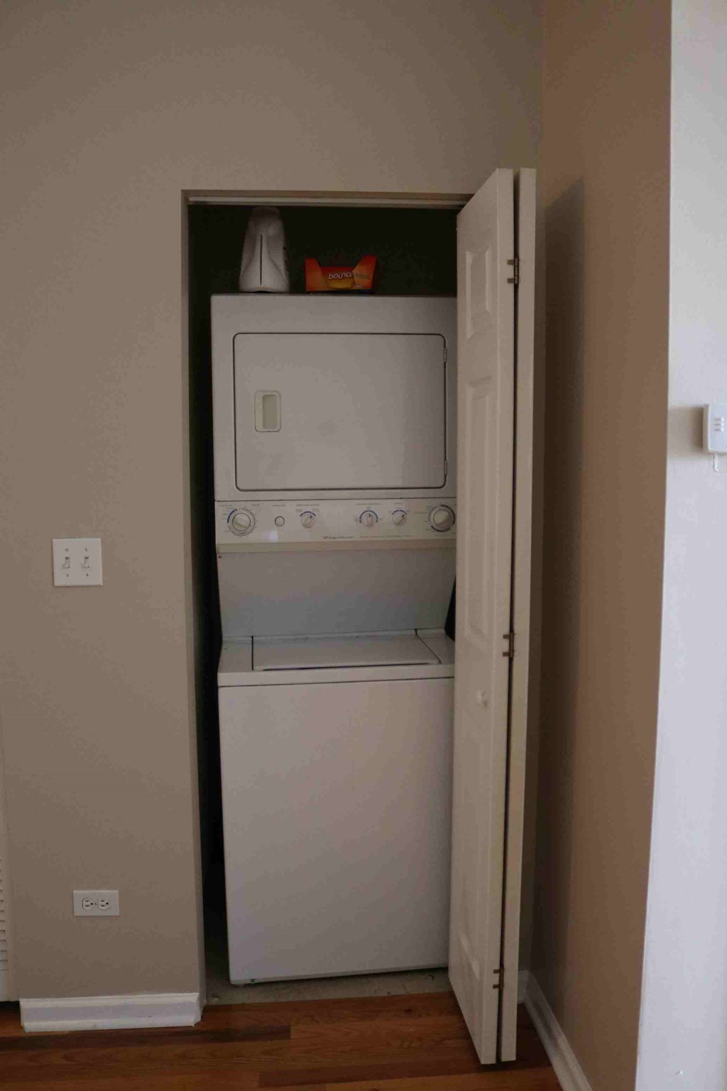 a white washer and dryer in a small closet