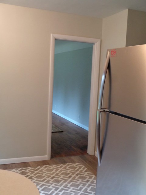a kitchen with a refrigerator and an open door