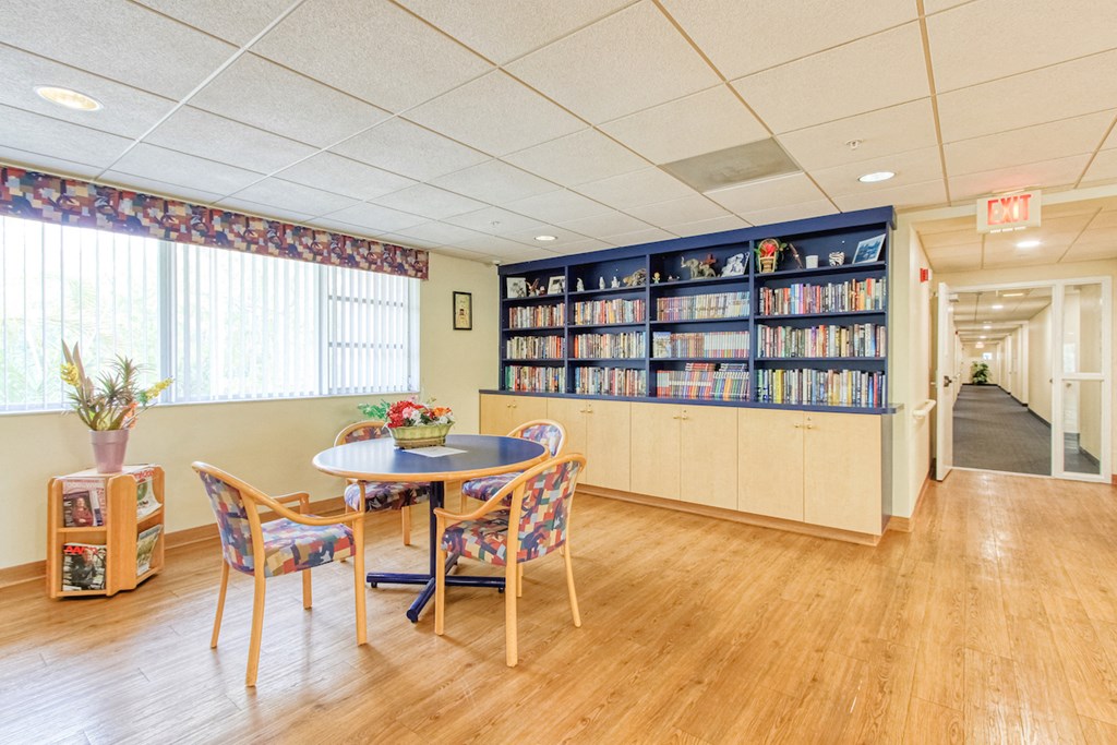 library with many books and reading tables and chairs