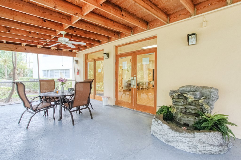 Covered Patio with table, chairs, and ceiling fan
