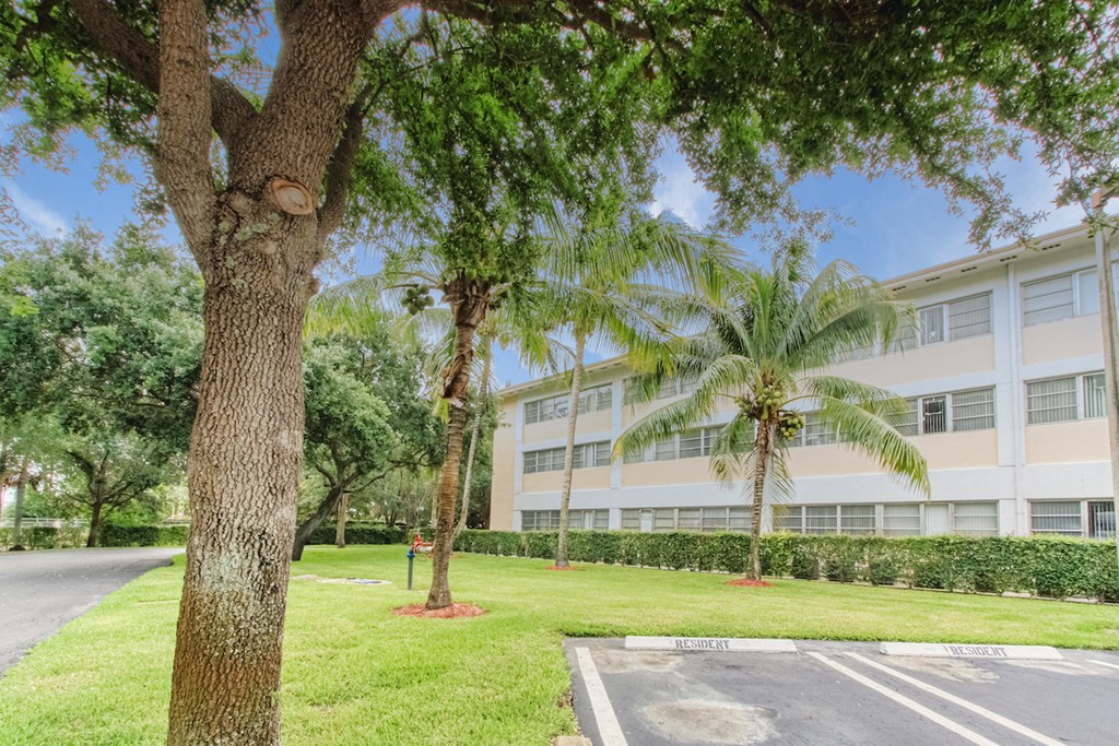 Parking lot surrounded by lush landscaping outside Villa Madonna