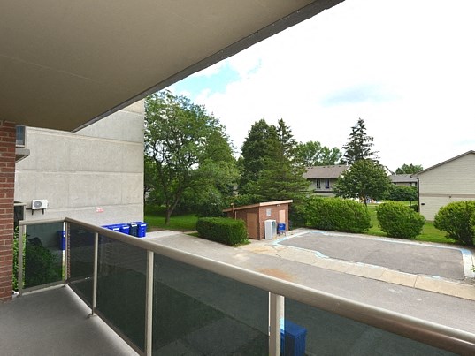 a view of a pool from the balcony of a house